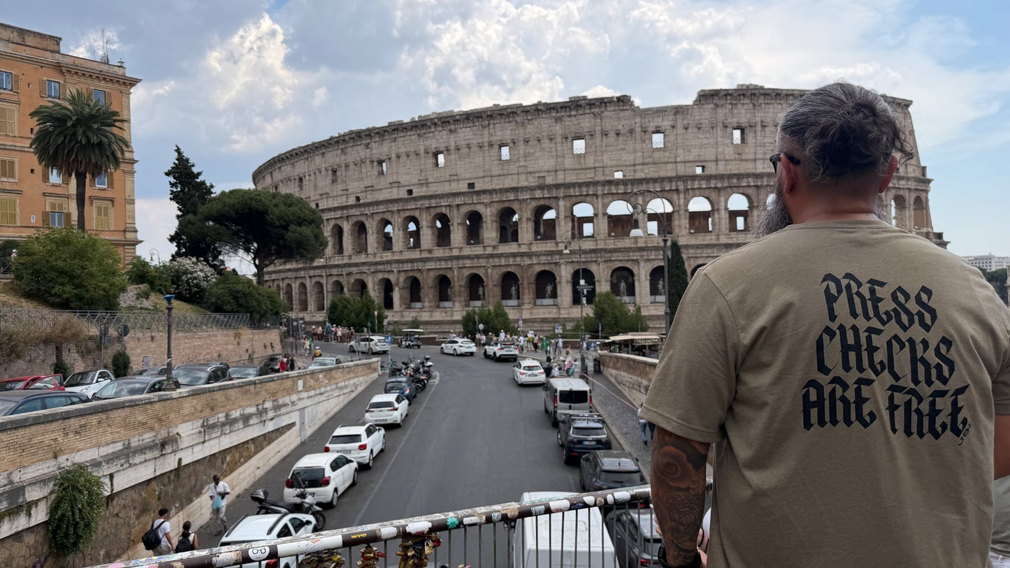PCAF Press Checks Are Free tee worn at the Colosseum in Rome